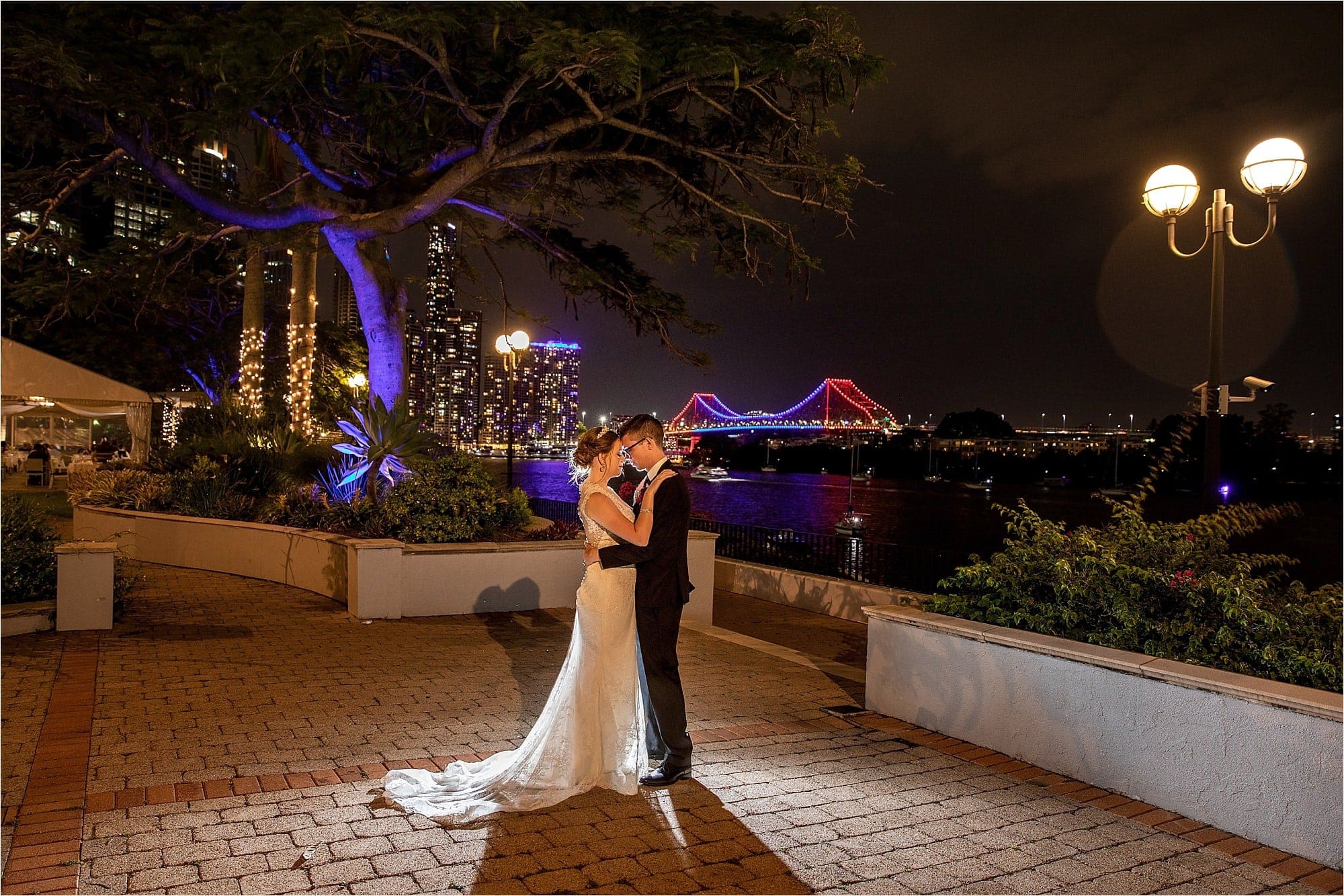 Brisbane Wedding photographer with a wedding couple over looking brisbane river and the story bridge, from the Stamford Plaza Hotel, Brisbane.
