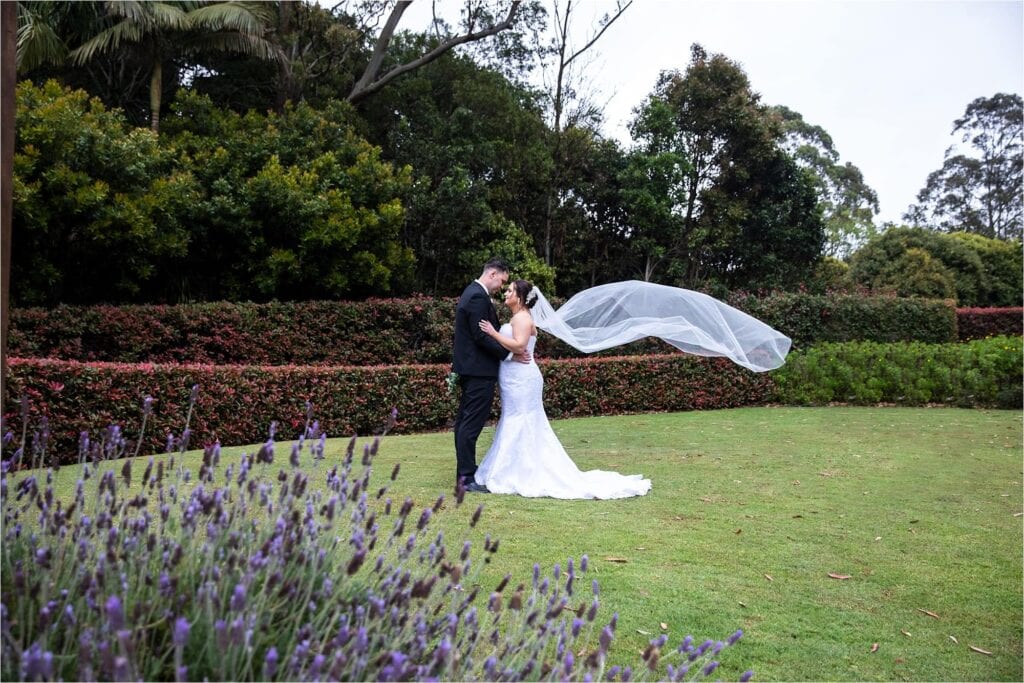 Tamborine Gardens Wedding Resort Photography bridal couple with veil flowing in the wind
