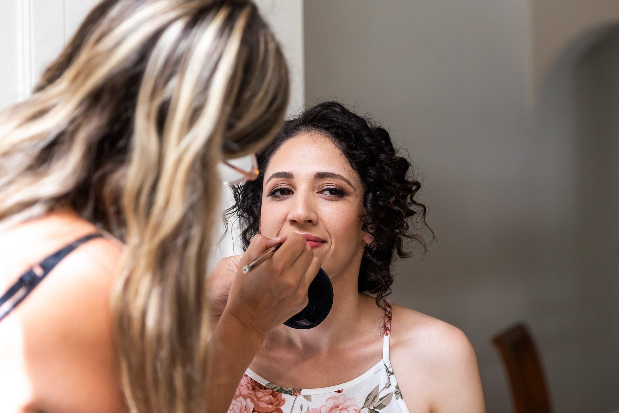 Bride having makeup done on her wedding day.