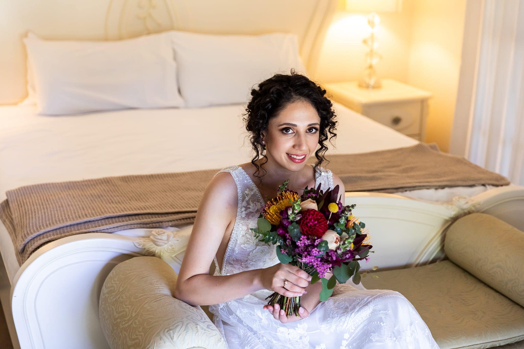 Bride sitting on the sofa at Coolibah Downs Private Estate Wedding Venue