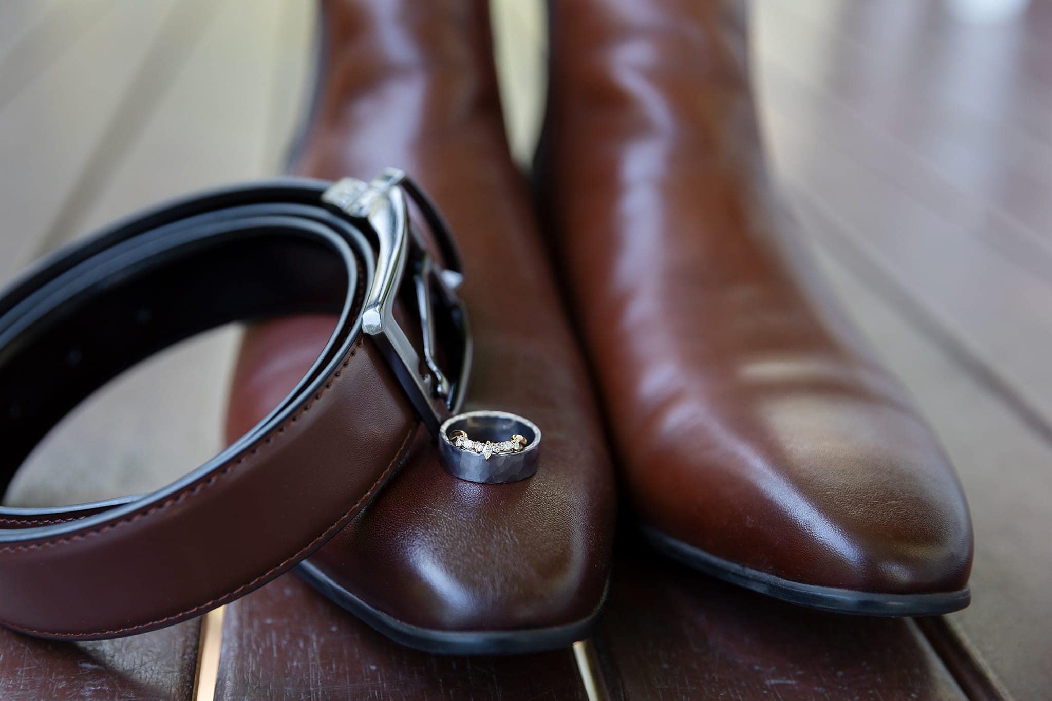 Grooms preparations with ring and belt on shoes
