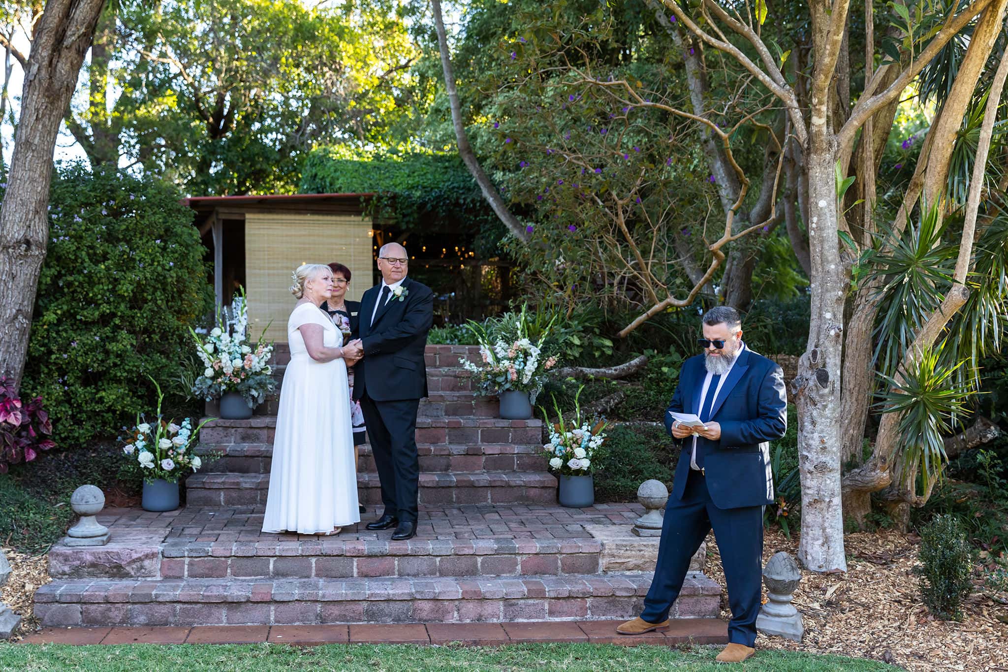 A wedding ceremony at The Secret Garden Estate, Tamborine Mountain by Mooi Photography.