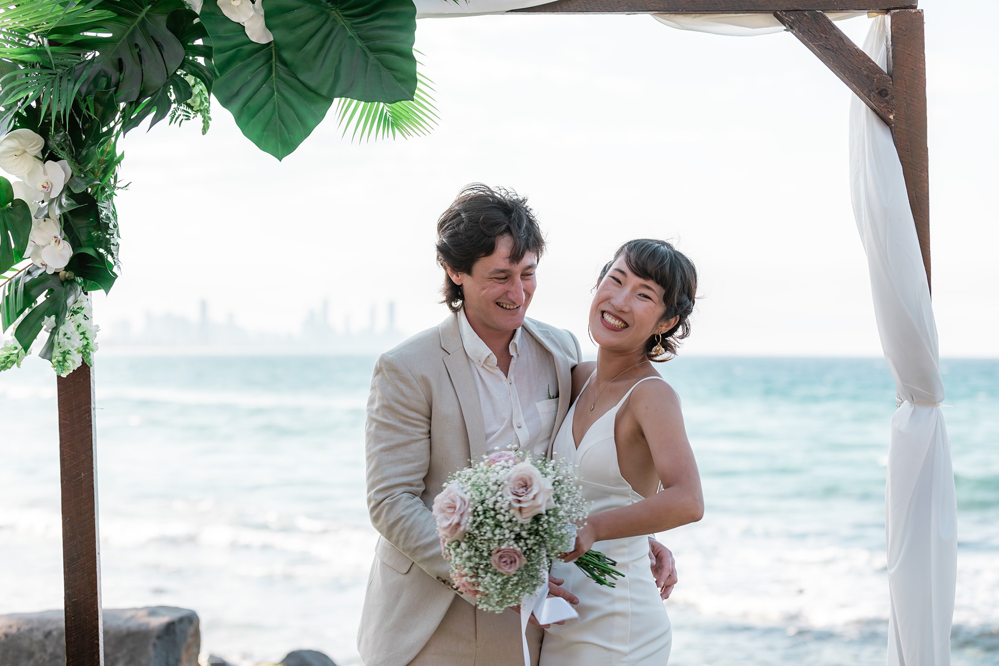 Bride and groom celebrating their wedding at Burleigh Heads on the Gold Coast.